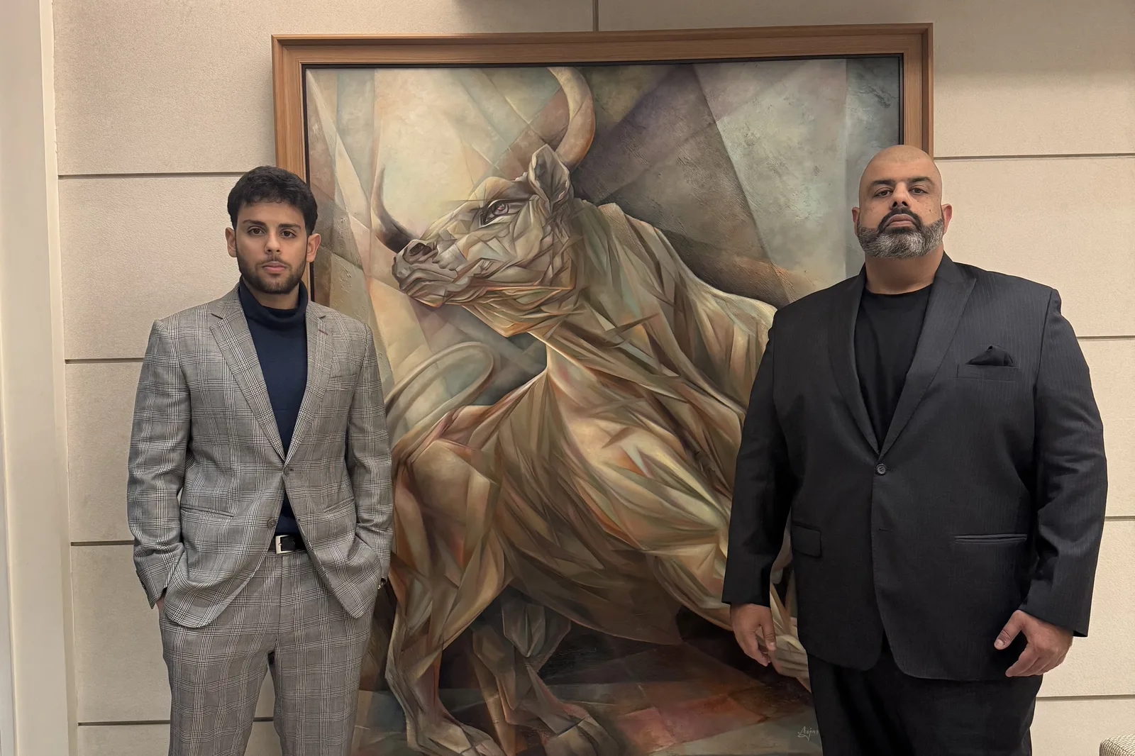 Rocky V. Bawa with his father in front of a bull painting